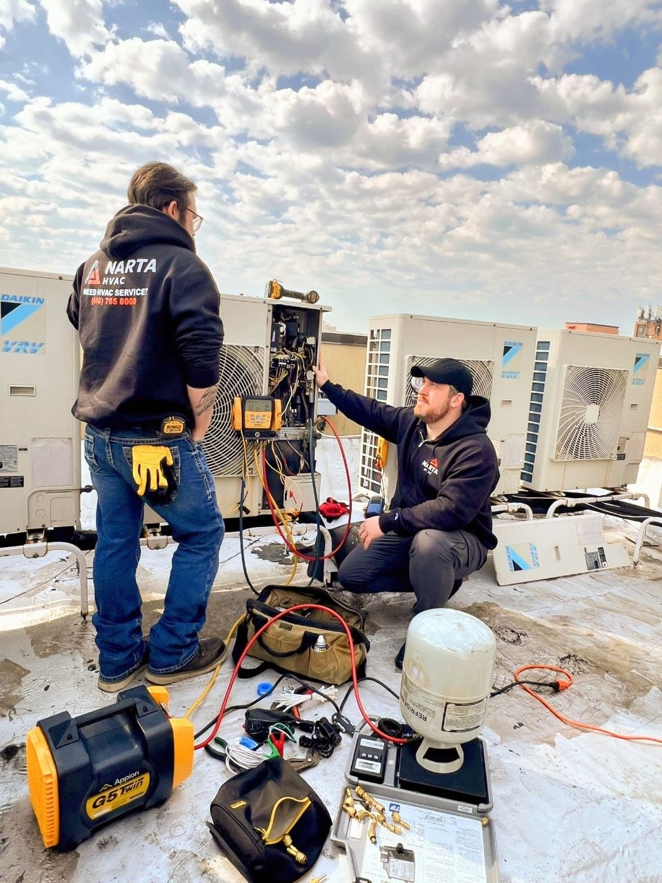 NARTA technician repairing an HVAC unit on a NYC rooftop
