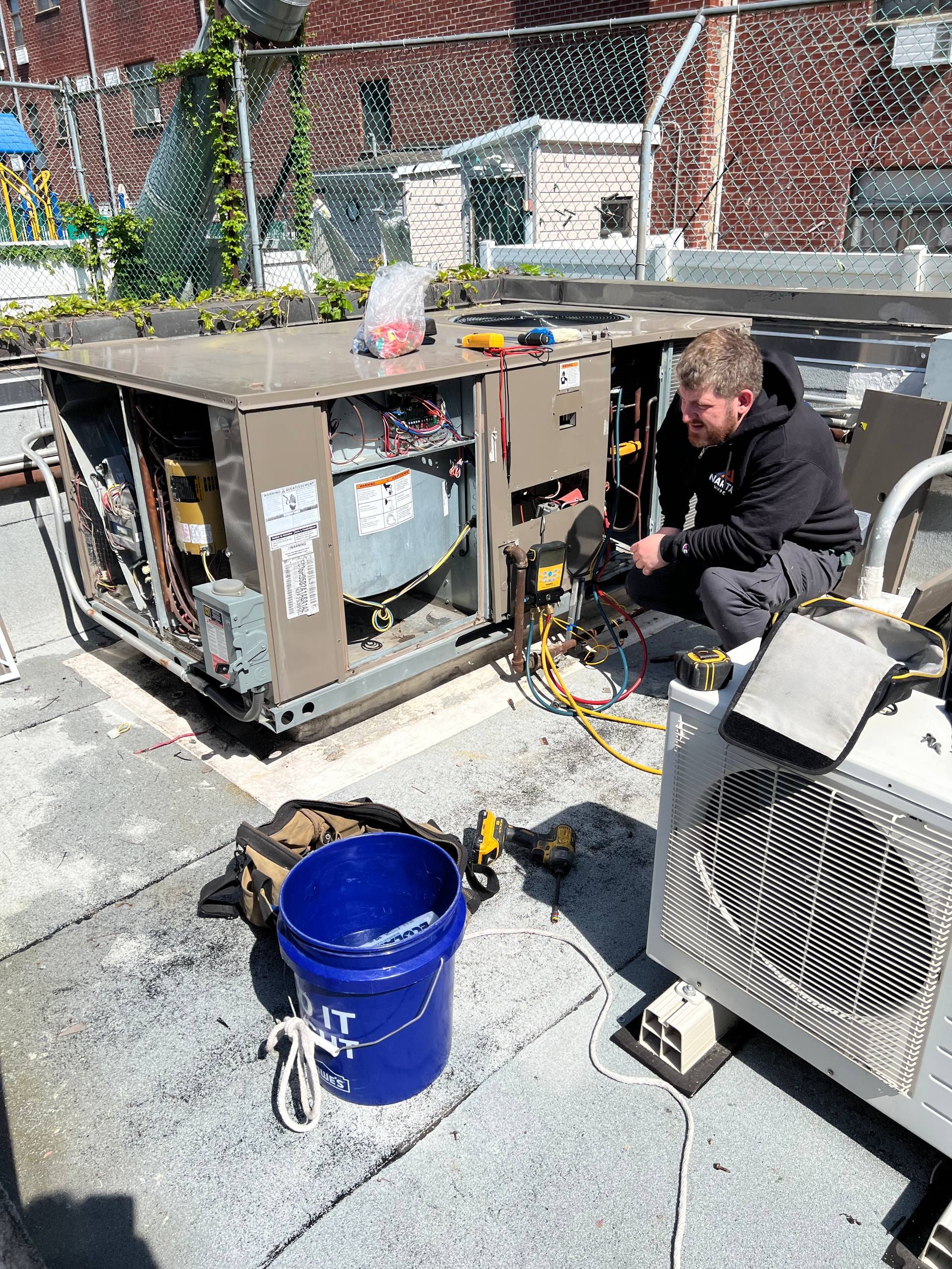 Rooftop HVAC maintenance before summer — worn drive belt, drain trap correction, and filter replacement identified during system inspection.